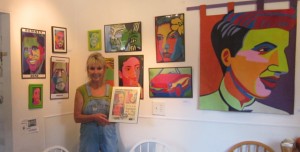 Nanci Killingsworth stands before Marcia Gawecki's Pop Art portraits