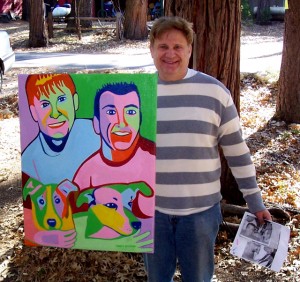 Idyllwild neighbor holding up portrait of him + partner with two dogs